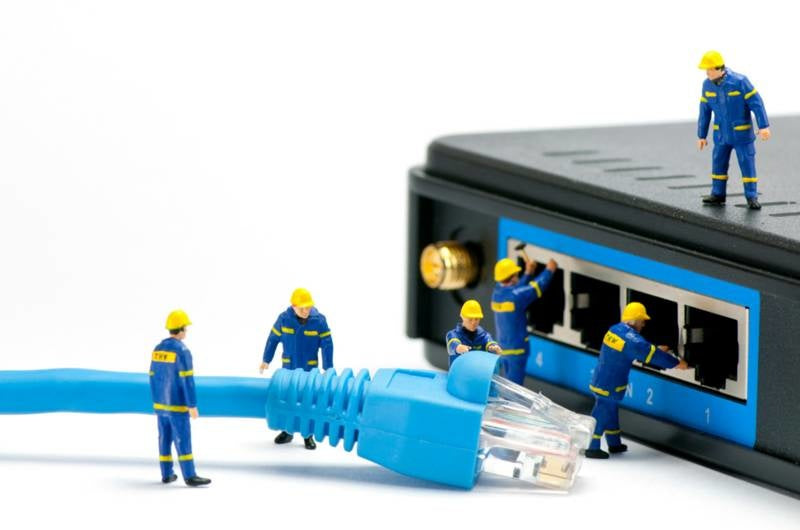 miniature-technicians-connecting-network-cable